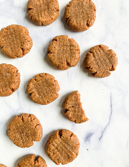 mini vegan date sweetened peanut butter cookies on a white background 