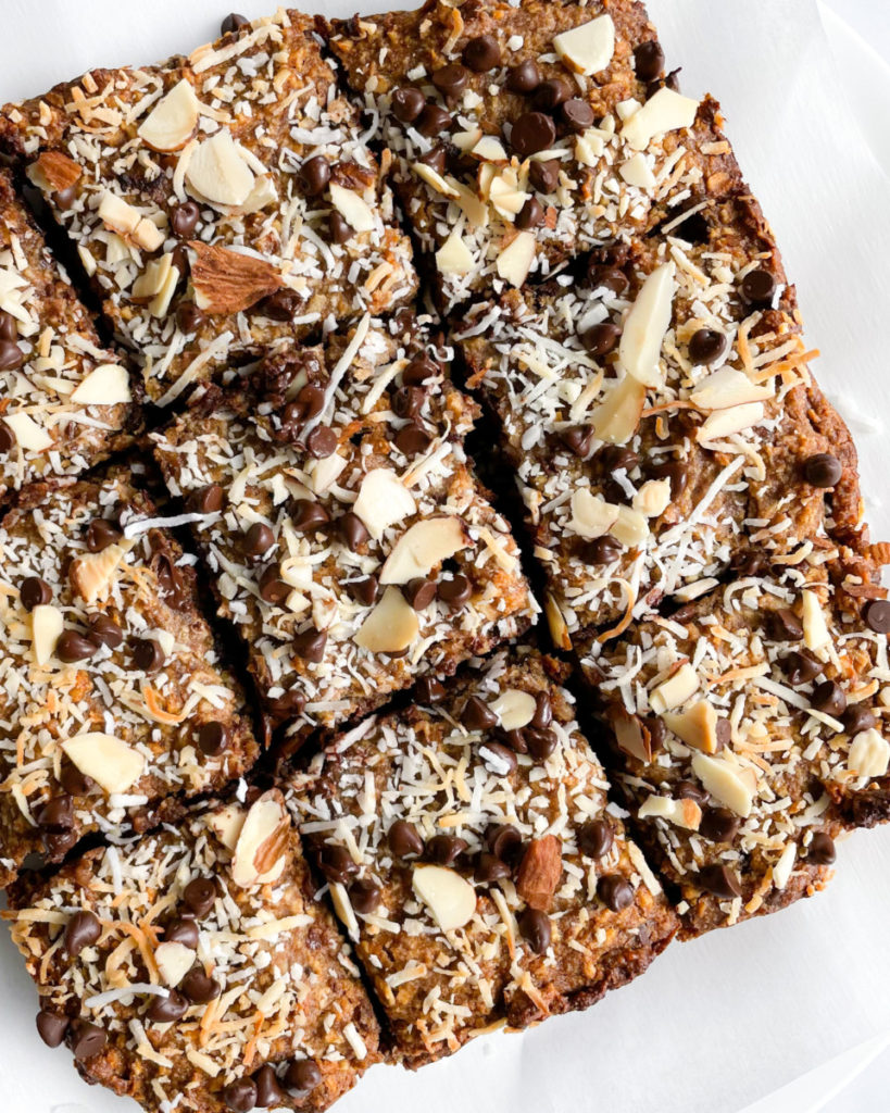 a vertical image of vegan date sweetened oatmeal breakfast bars on a white plate 