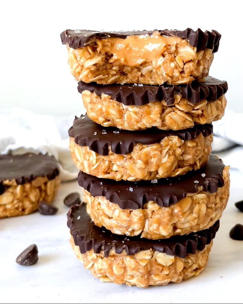 gluten-free vegan no bake peanut butter oat cups stacked on a white counter top