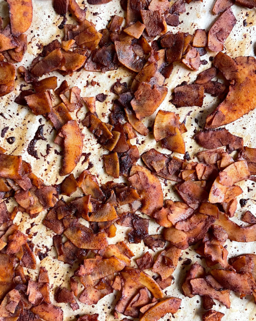 a close up photo of vegan coconut bacon on a baking sheet 