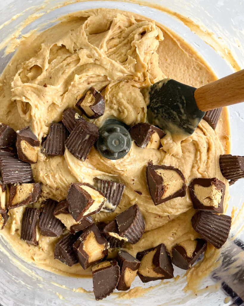 a close up photo of vegan peanut butter cup nice cream with peanut butter cups in a food processor 